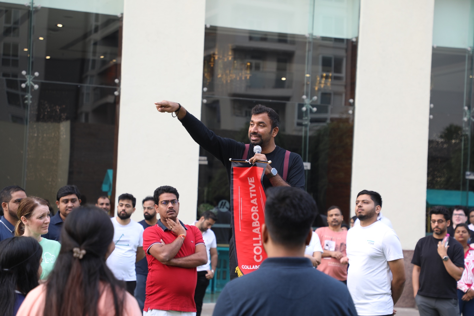 Saveen Hegde speaking to a live audience